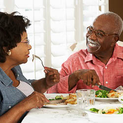 Older adult Black couple eating a meal together