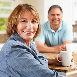 Older adult Hispanic couple drinking coffee together