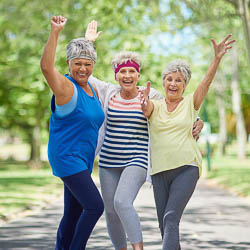 3 older adult women exercising outdoors