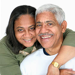 Older adult black couple hugging