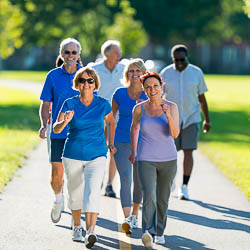 group of older adults walking in park